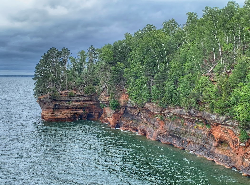 Sea cliffs with pine trees and red rock on lake superior