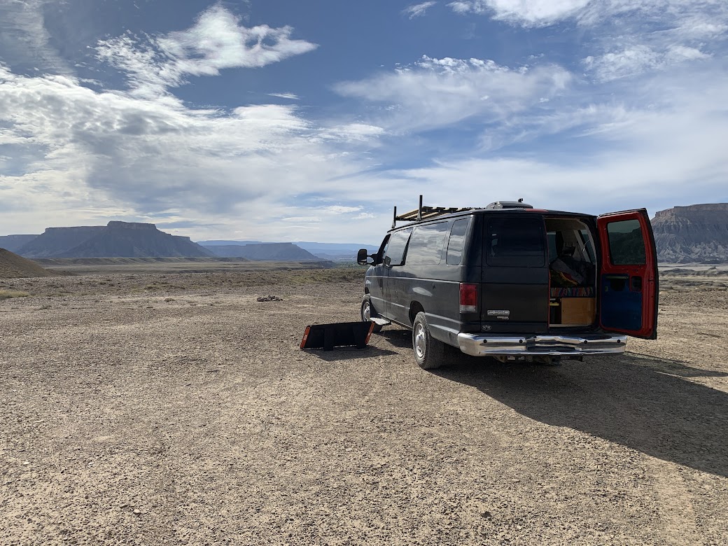 black econoline van parked in a wide open wester space on a sunny day