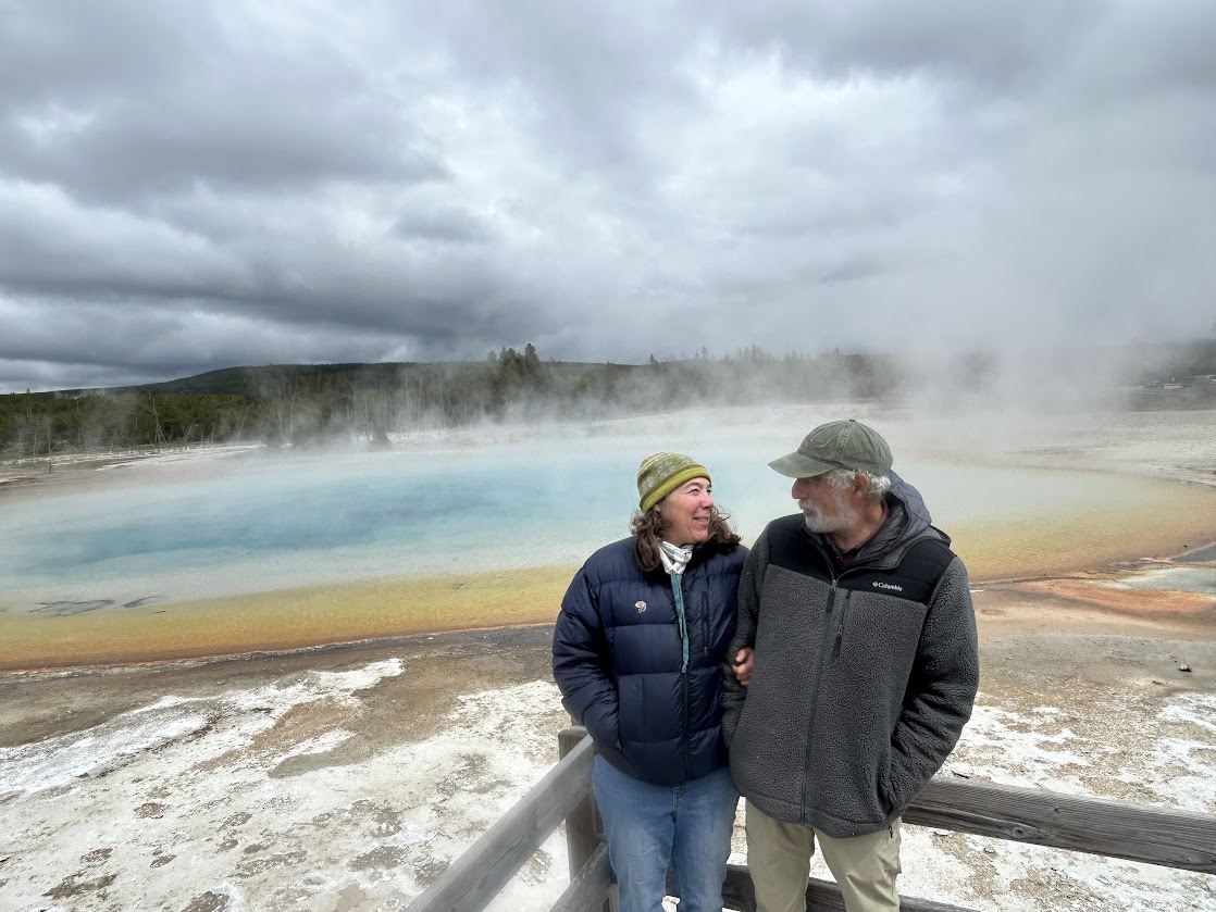 couple beside a hot springs in yellowstone