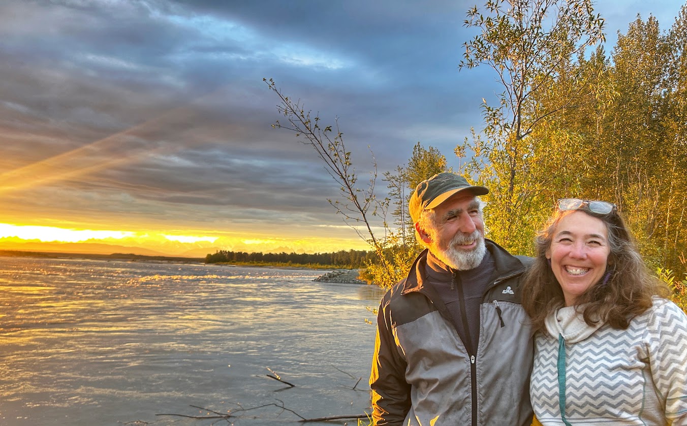 couple selfie with sunset in background